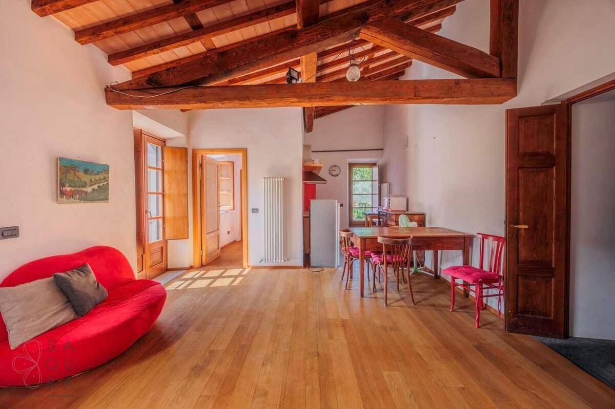 Offener Wohn-Essbereich mit Holzboden und Holzbalkendecke, bietet viel Platz und Licht.