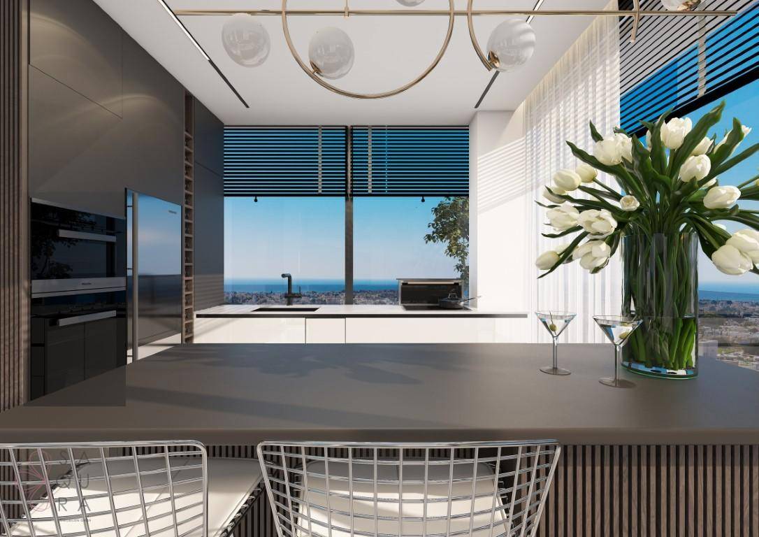 Helle, moderne Küche mit Spüle, Kochfeld und raumhohen Fenstern, die einen spektakulären Blick auf das Meer bieten.