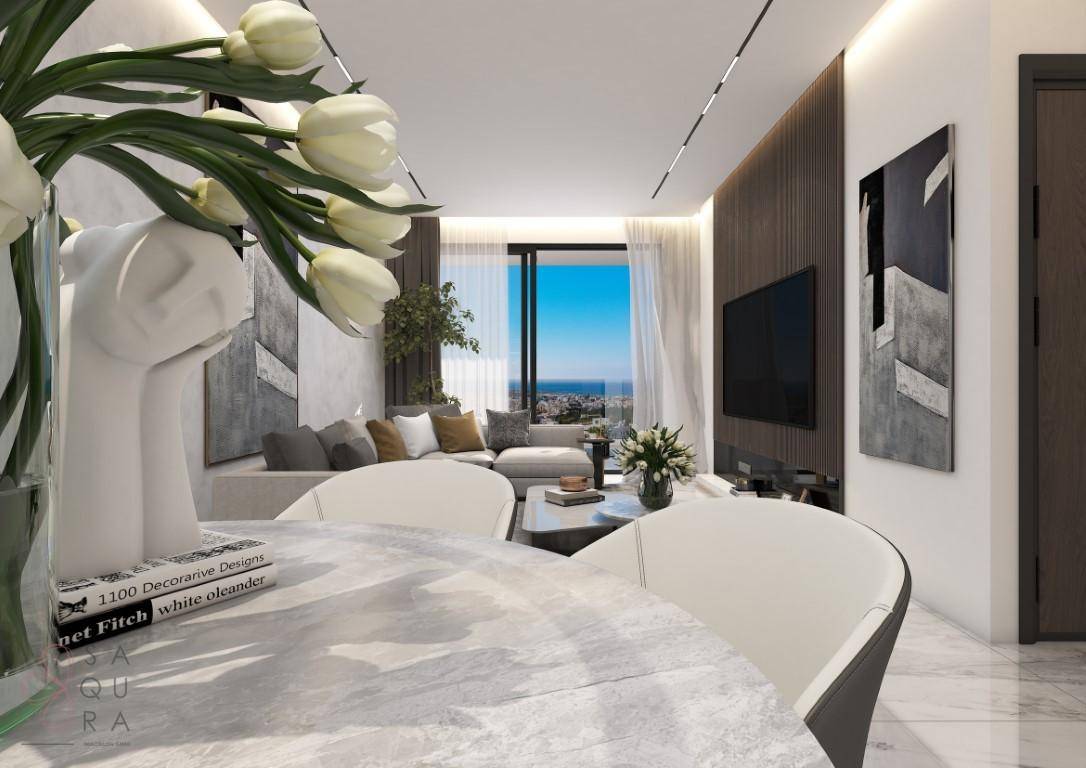 Offener Wohn- und Essbereich mit modernem Design, hellem Sofa und weitem Blick auf das Meer.