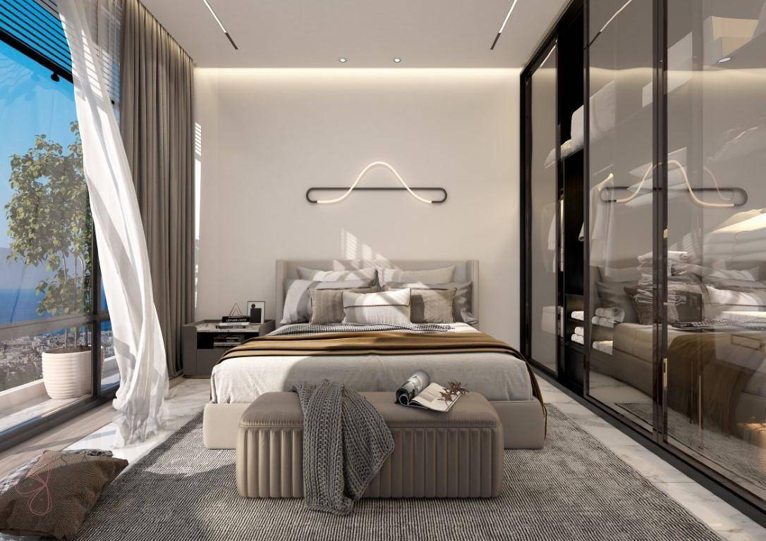 Modernes Schlafzimmer mit großem Bett, eleganten Glasschränken und Zugang zum Balkon mit Meerblick.