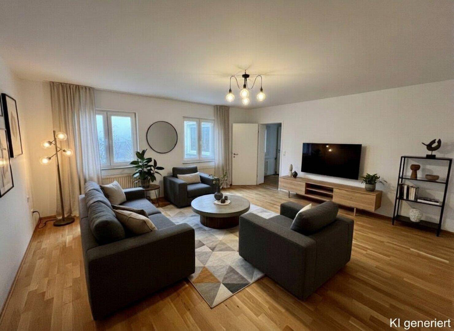 Helles Wohnzimmer mit bequemen grauen Sofas, Holzboden und modernen Leuchten, ideal zum Entspannen.