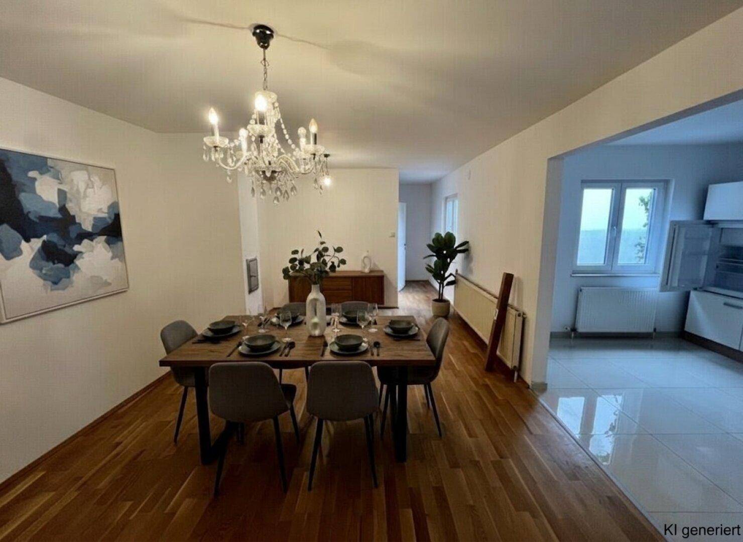 Eleganter Essbereich mit großem Holztisch, Kronleuchter und Zugang zu einer modernen Küche.