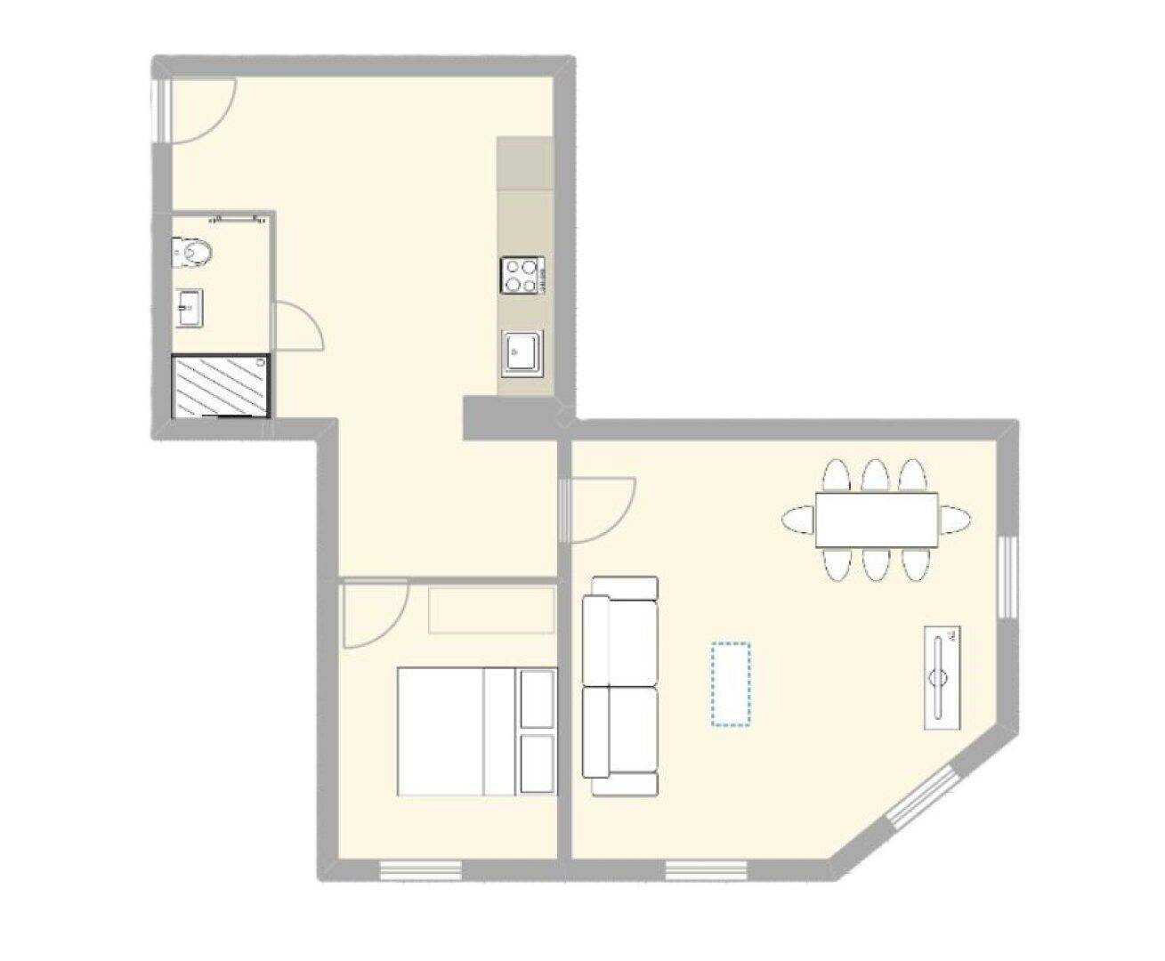 Grundriss einer Wohnung mit Schlafzimmer, Bad, Küche und offenem Wohn-Essbereich.