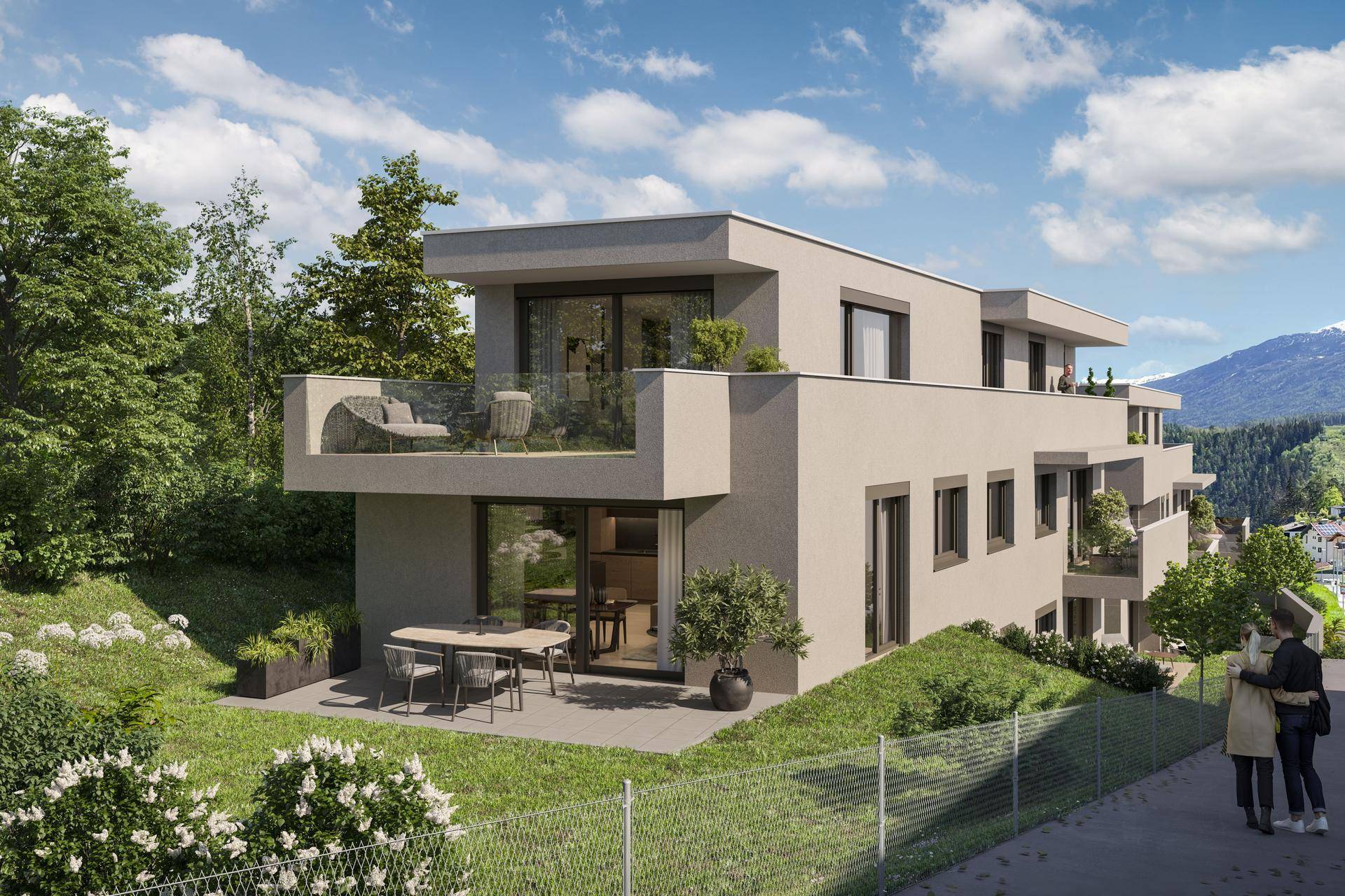 Moderne Wohnanlage mit großzügiger Terrasse und Gartenbereich, eingebettet in grüne Umgebung.