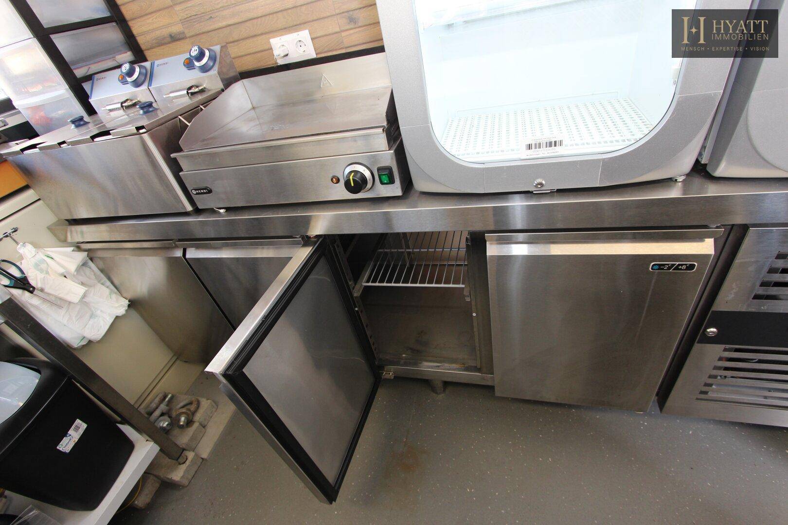 Geöffnete Unterbau-Kühlschränke aus Edelstahl in der professionellen Kiosk-Küche.