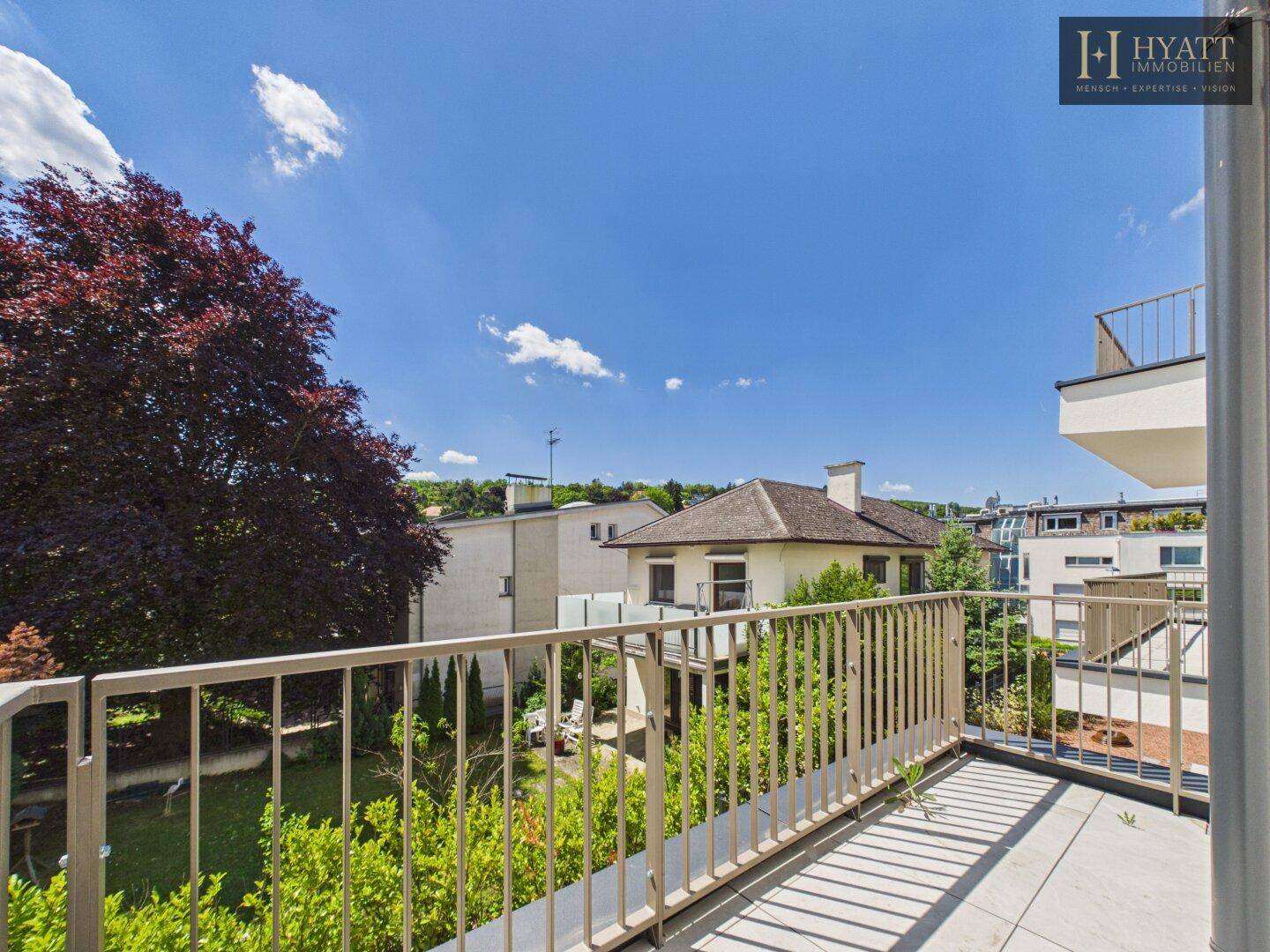 Geräumiger Balkon mit Metallgeländer und weitem Blick über die Umgebung.