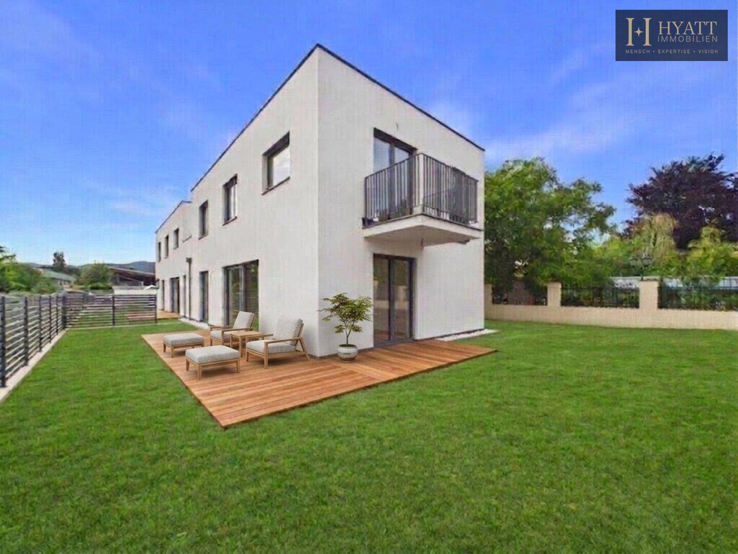 Ansicht des modernen Hauses mit weitläufiger Holzterrasse, Gartenmöbeln und großem Rasen.