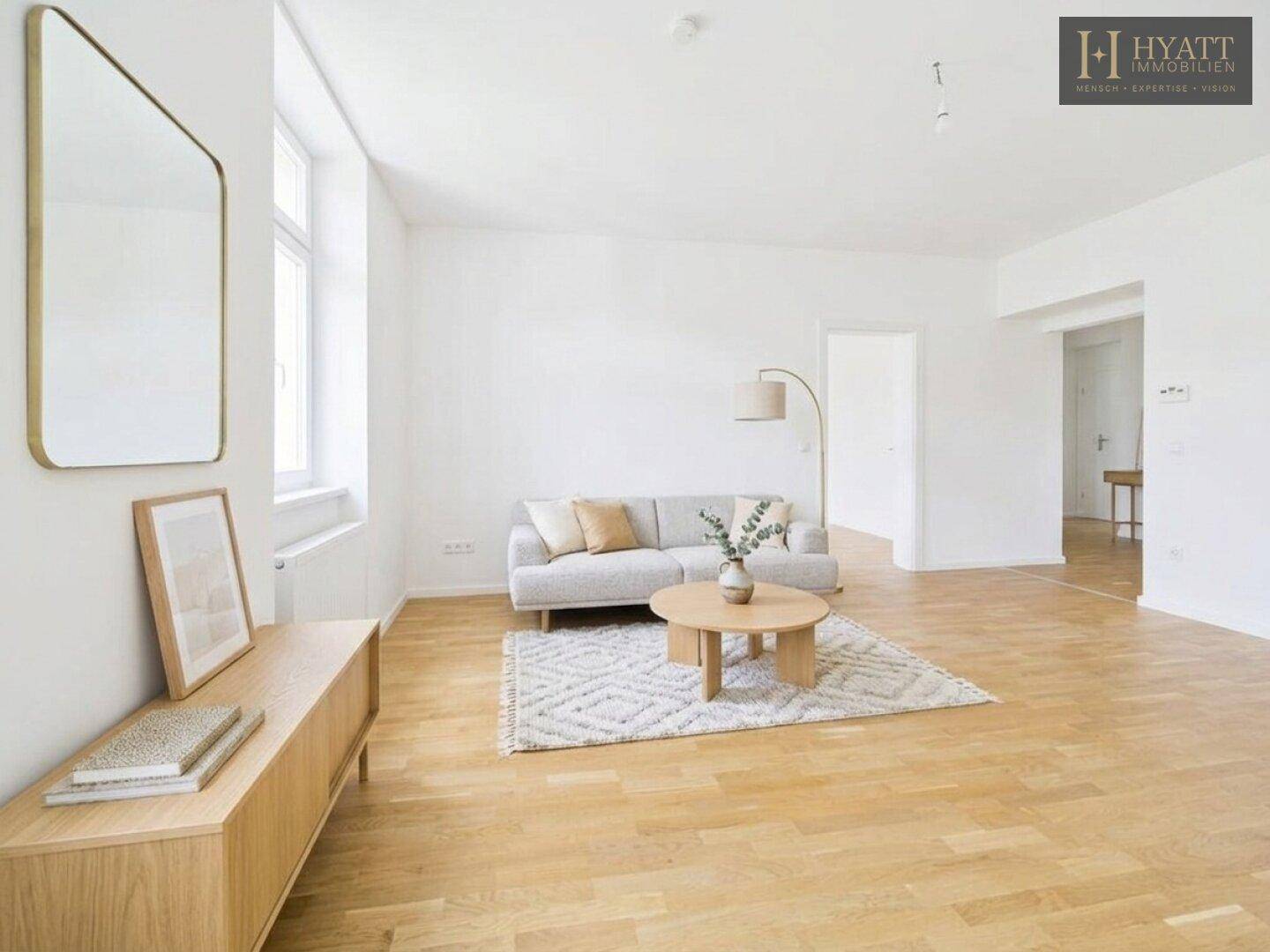 Gemütliches Wohnzimmer mit hellem Holzboden, modernem Teppich und stilvoller Einrichtung.