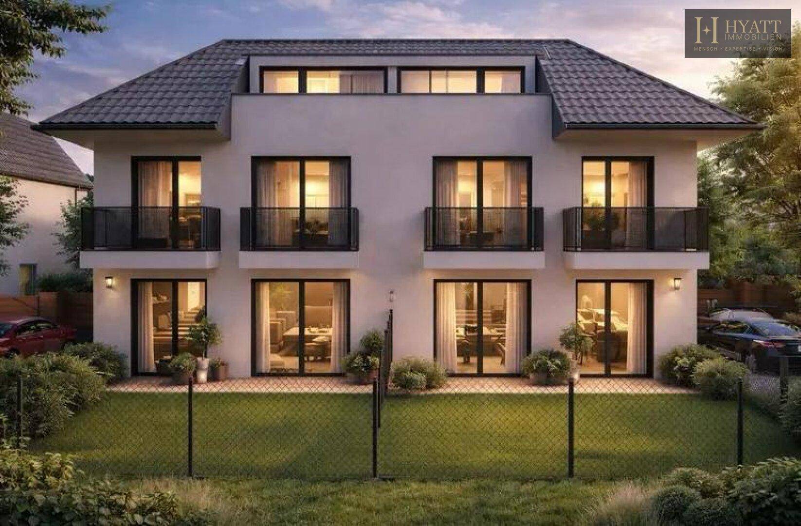 Vorderansicht der modernen Doppelhaushälfte mit kleinen Balkonen und gepflegtem Vorgarten.