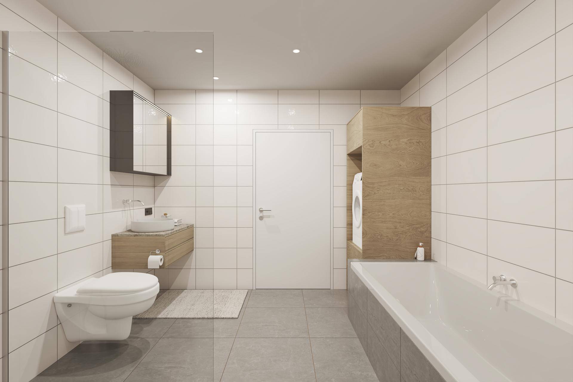 Helles Badezimmer mit Badewanne, Wand-WC und integriertem Schrank für Waschmaschine und Trockner.