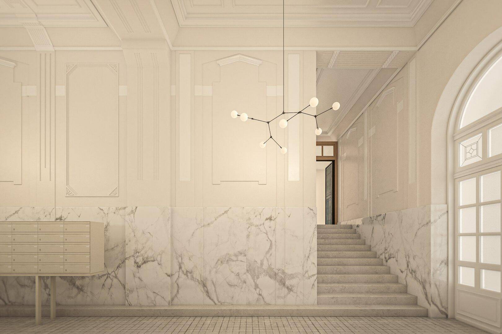 Elegante Eingangshalle mit Marmorverkleidung, Stuckelementen, hoher Decke und moderner Beleuchtung.