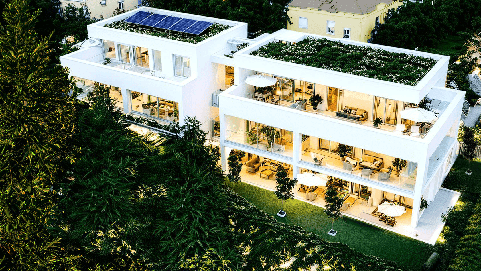Luftaufnahme einer modernen Wohnanlage mit begrünten Dächern und Solaranlagen.