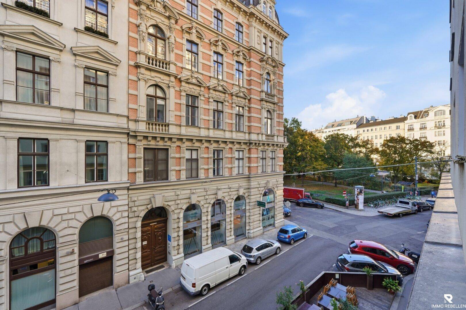 Blick von einem Balkon auf die belebte Straße und die umliegenden Gebäude.
