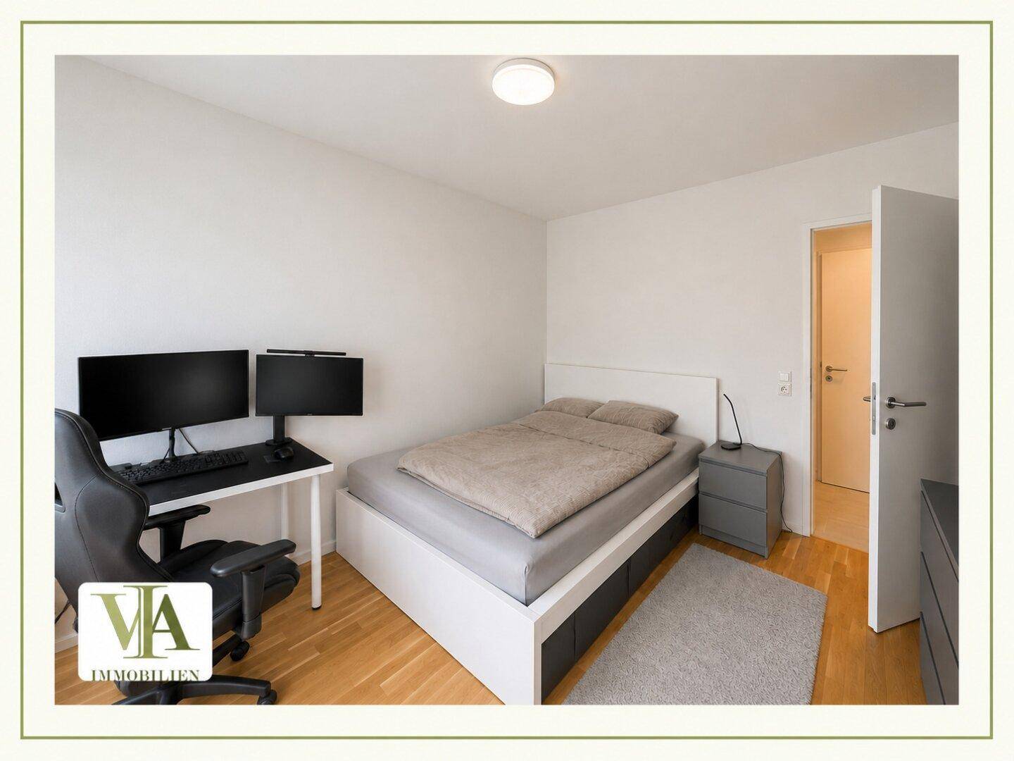 Modernes Schlafzimmer mit Doppelbett, Nachttischen und Schreibtischbereich.
