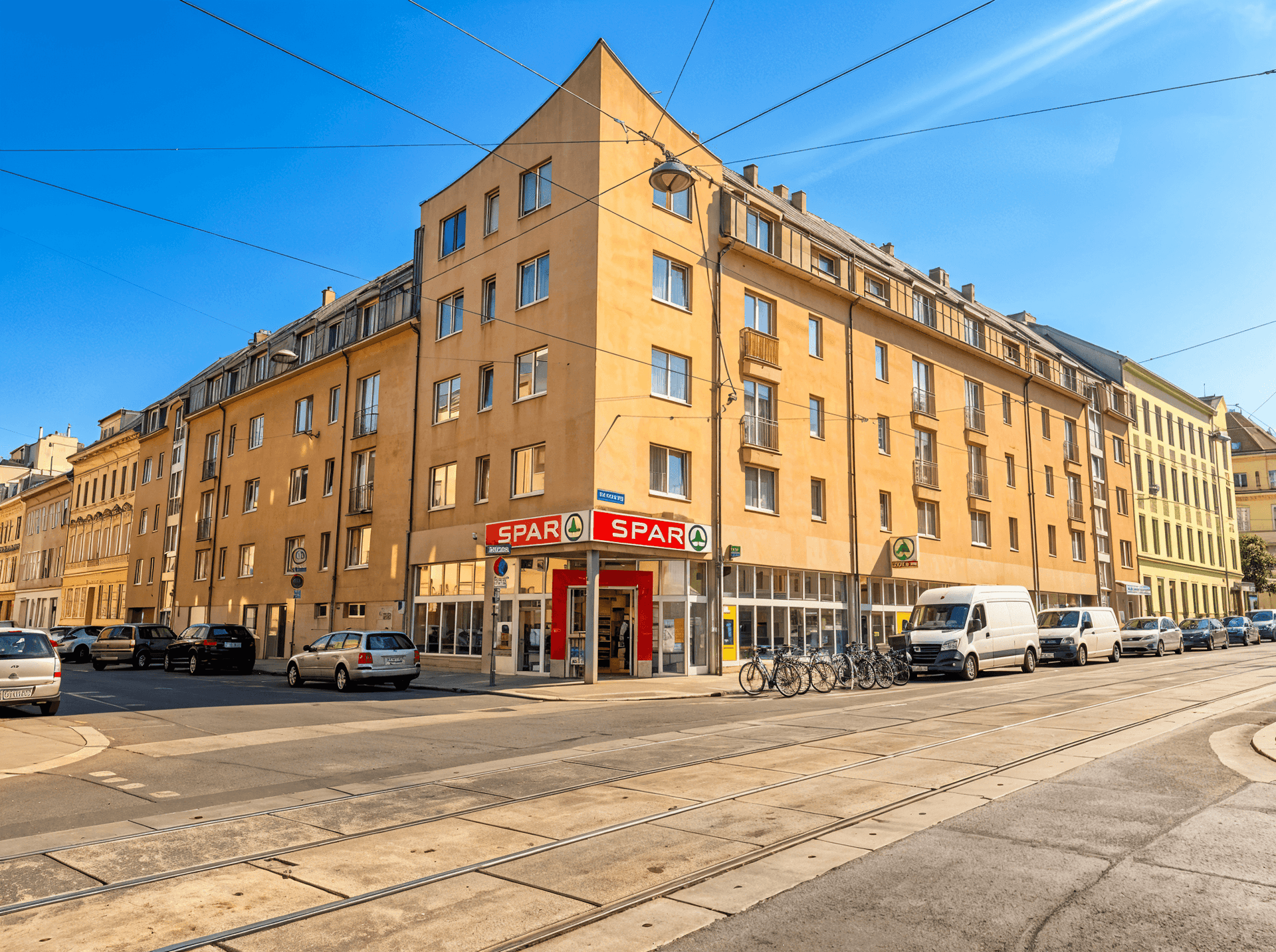 Eckgebäude mit einem Supermarkt im Erdgeschoss an einer belebten Stadtstraße.