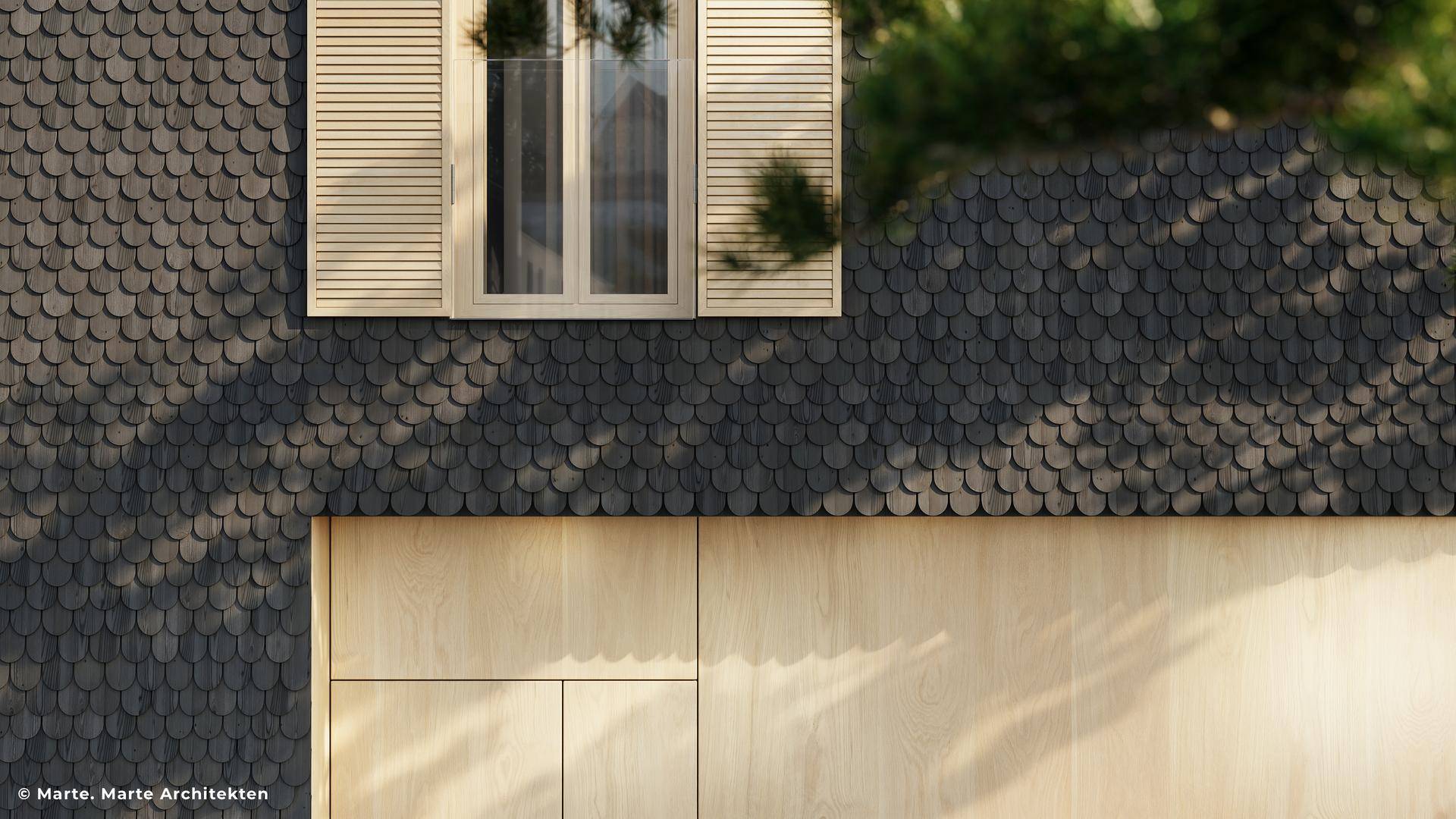 Nahaufnahme einer modernen Fassade mit dunklen Schindeln und hellen Holzpaneelen sowie einem Fenster mit Fensterläden.