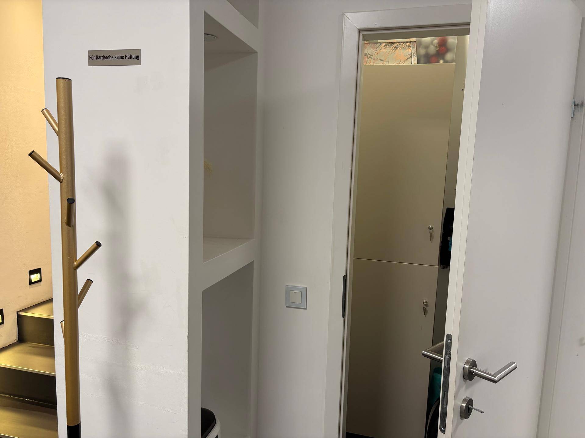 Flur mit Garderobe und Zugang zu Umkleidekabinen oder Lagerräumen.