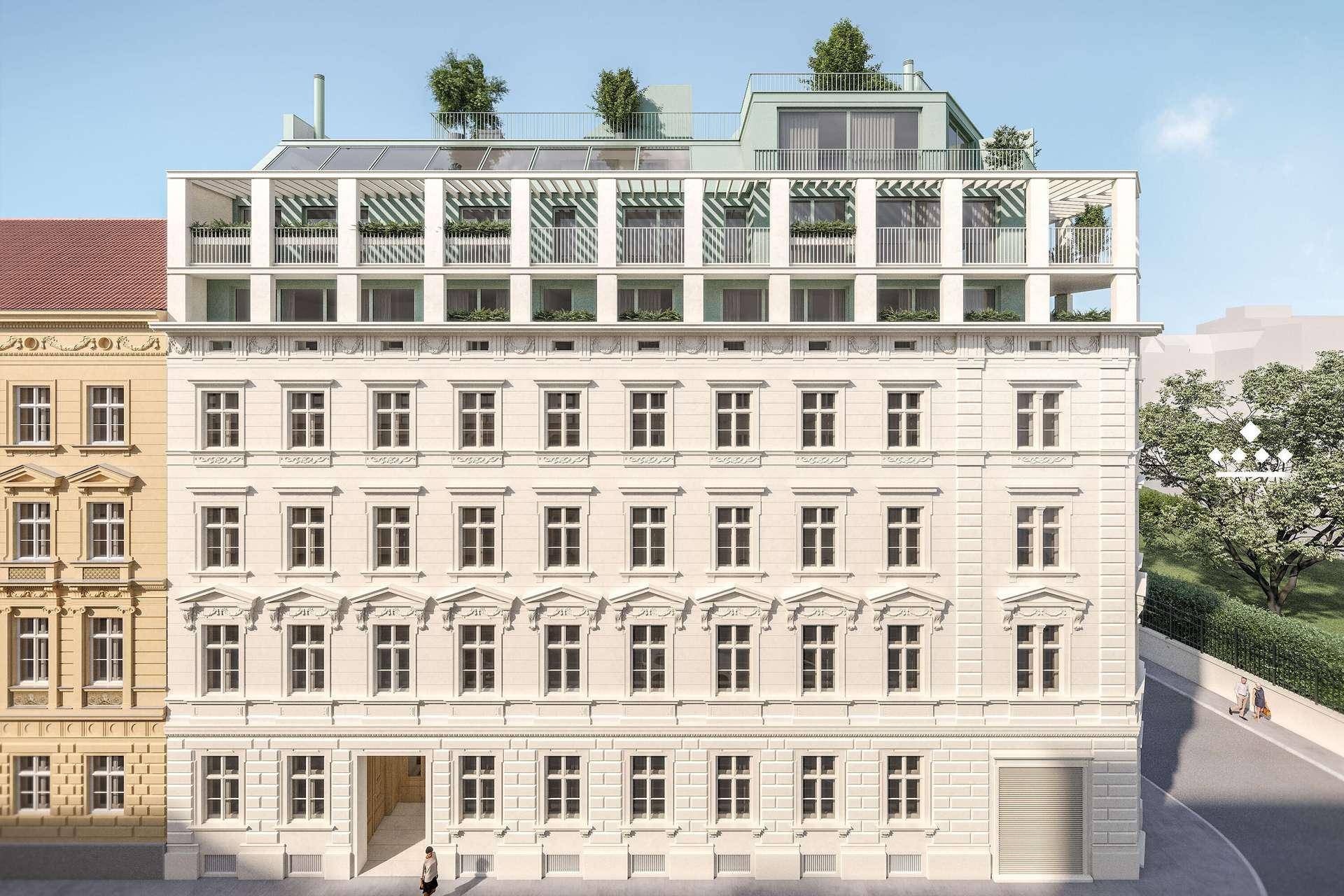 Klassische Fassade des Gebäudes mit modernen Dachaufbauten und vielen Fenstern.