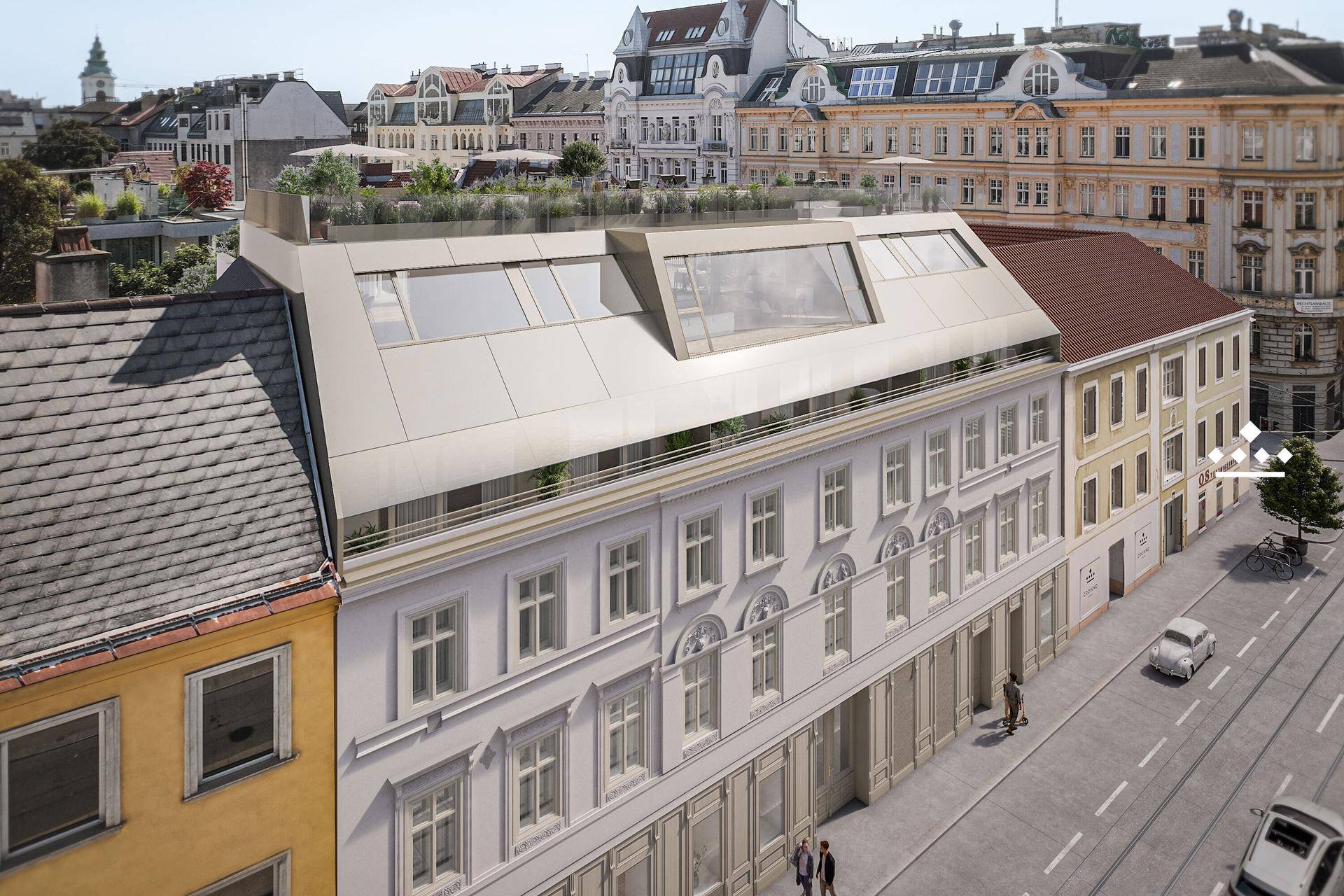 Luftaufnahme des Gebäudes mit modernem Dachgeschoss und Dachterrasse inmitten der Stadt.
