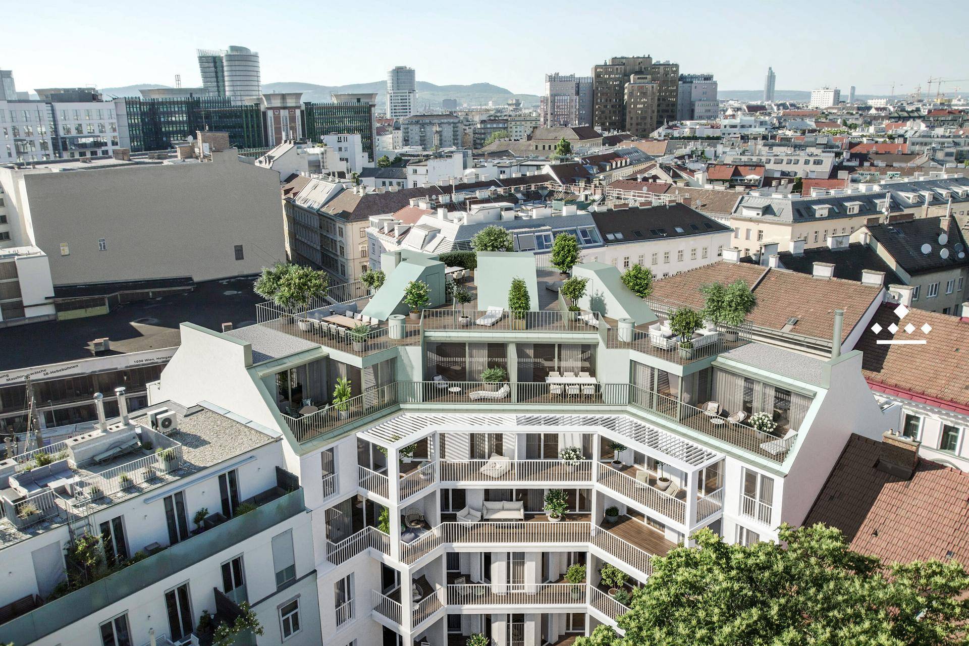 Luftaufnahme des modernen Gebäudes in städtischer Umgebung mit Dachterrassen.