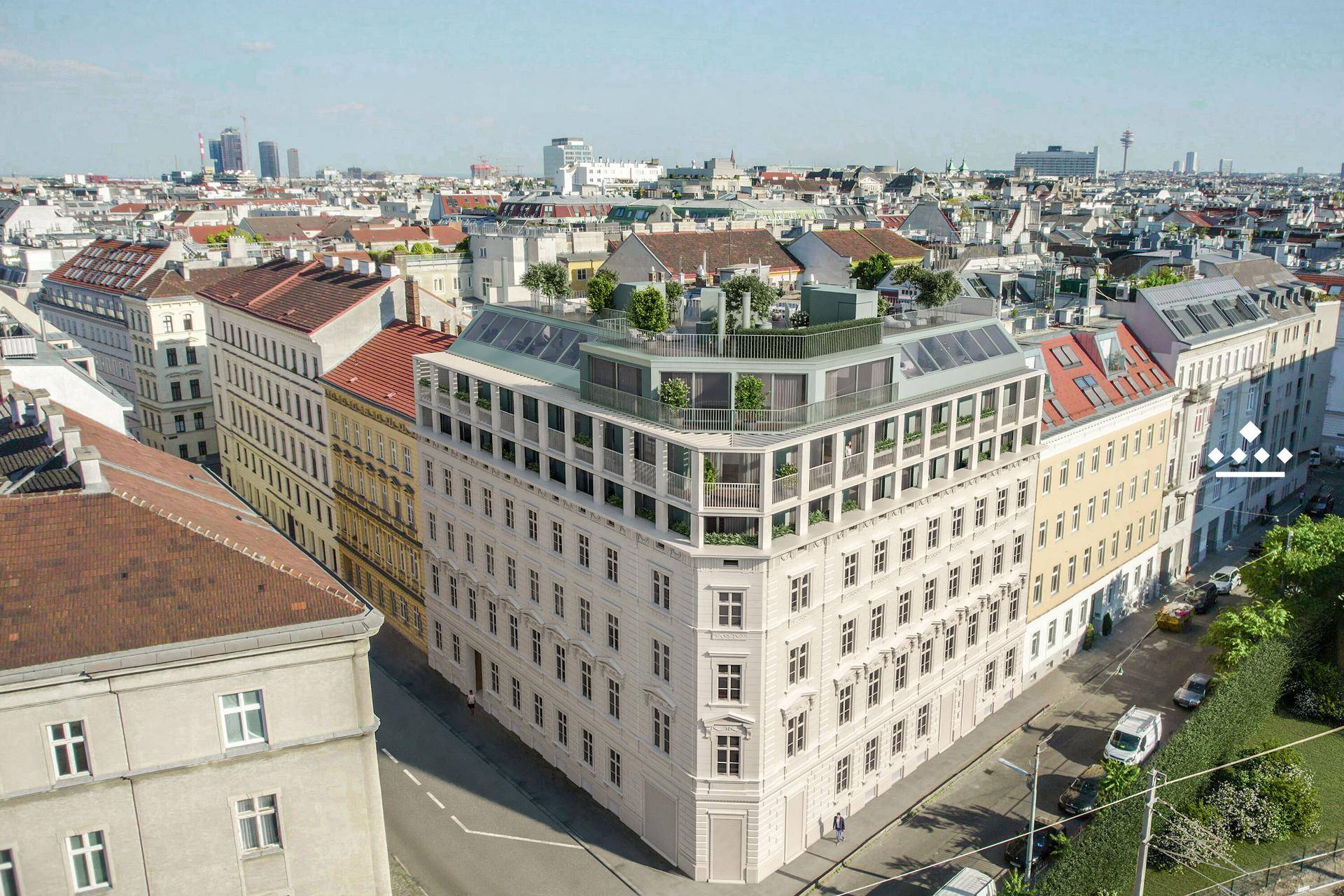 Luftaufnahme des modernen Gebäudes in urbaner Umgebung mit Dachterrassen und Stadtblick.