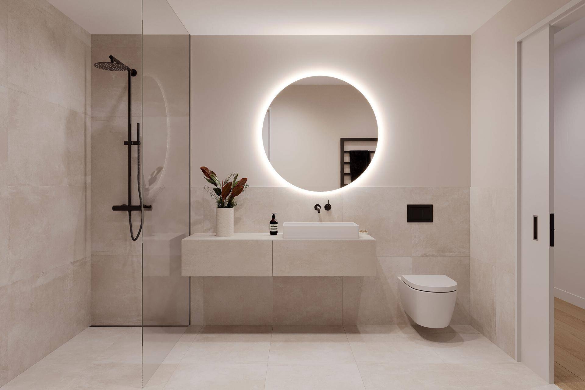 Modernes Badezimmer mit begehbarer Dusche, schwebendem Waschtisch und beleuchtetem Rundspiegel.