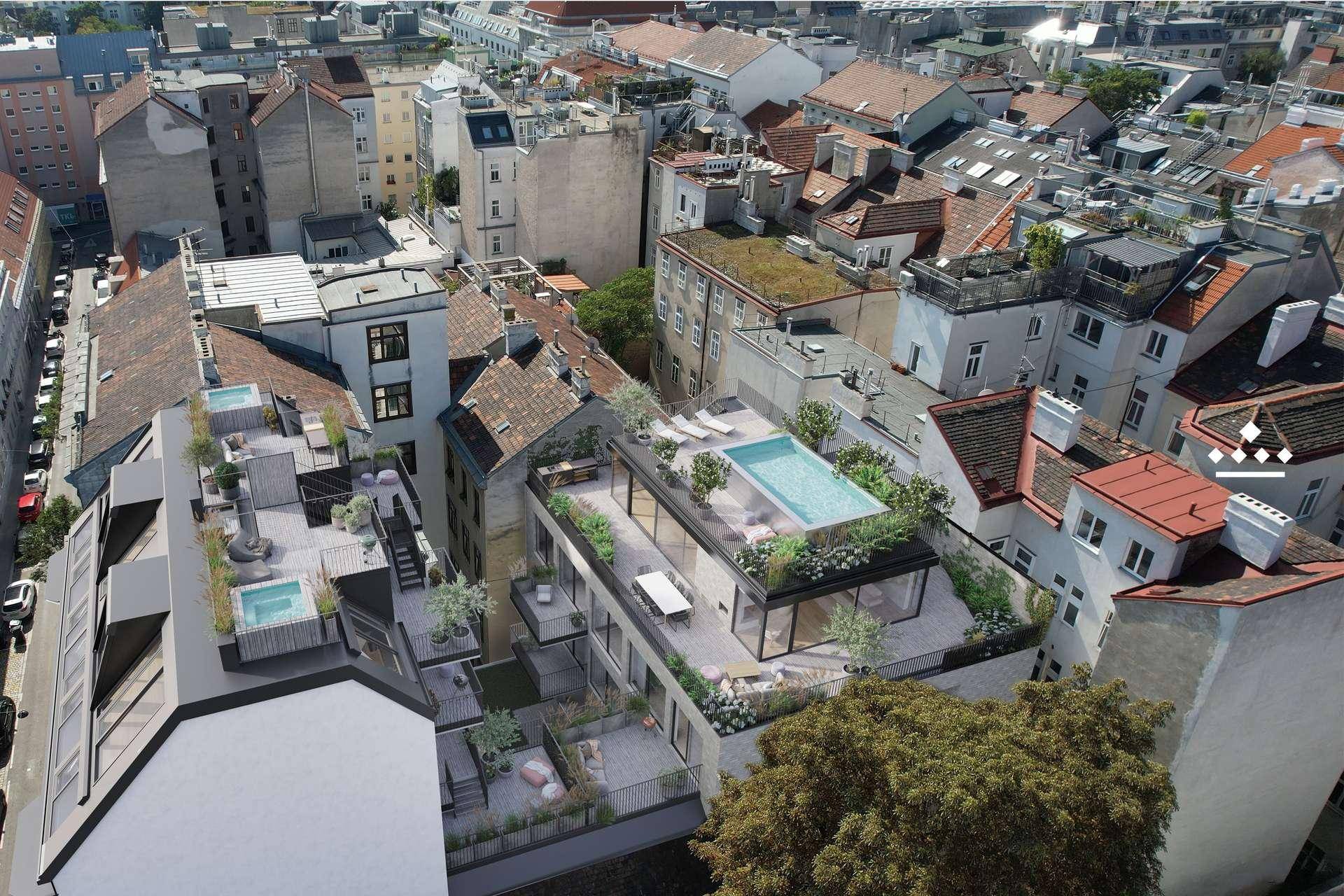 Luftaufnahme eines modernen Wohnkomplexes mit Dachterrassen, Pools und urbaner Umgebung.