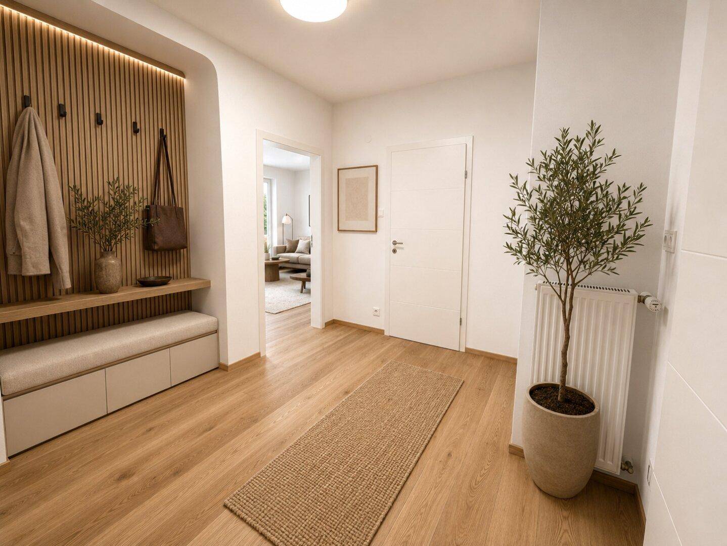 Moderner Eingangsbereich mit Holzvertäfelung, Sitzbank und hellem Holzfußboden.
