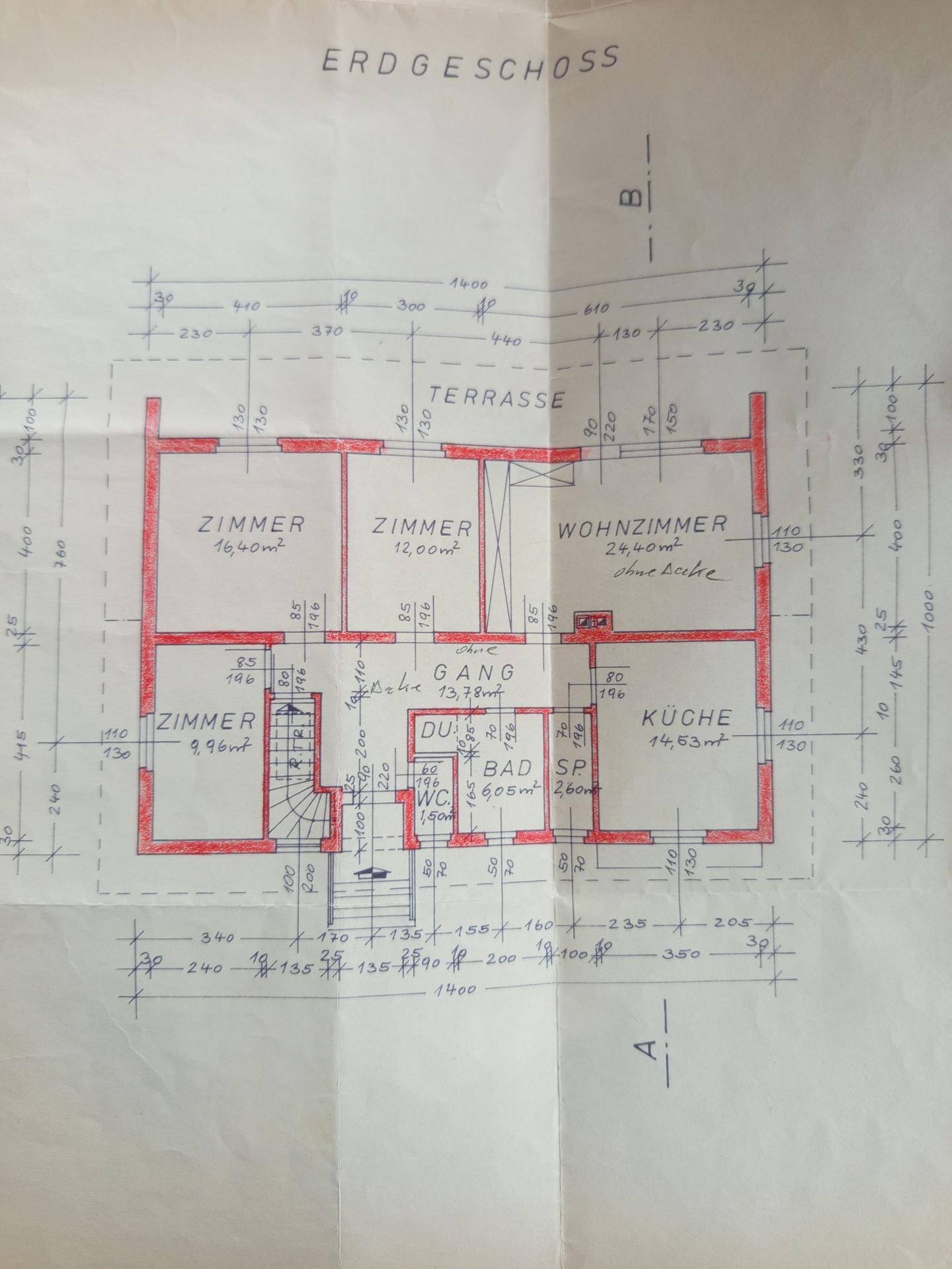 Grundriss des Erdgeschosses mit Wohnzimmer, Küche, Zimmern und Terrasse.