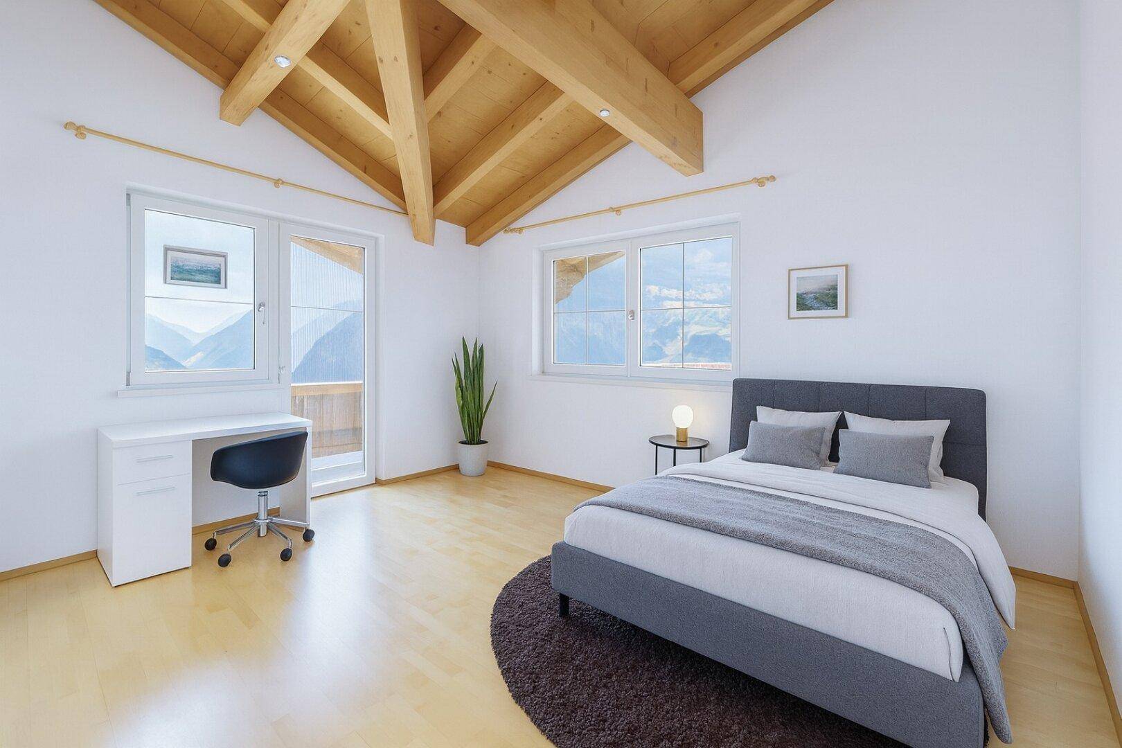 Schlafzimmer mit hohen Decken, sichtbaren Holzbalken, Parkettboden und Bergblick.