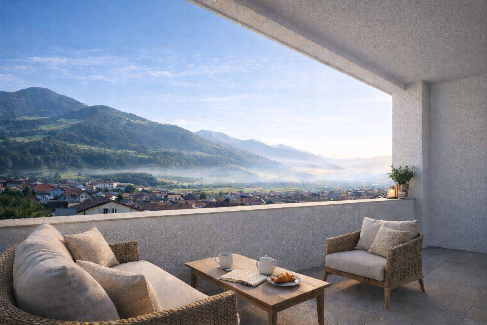 Geräumiger Balkon mit bequemen Loungemöbeln und atemberaubendem Blick auf die Berge und das Tal.