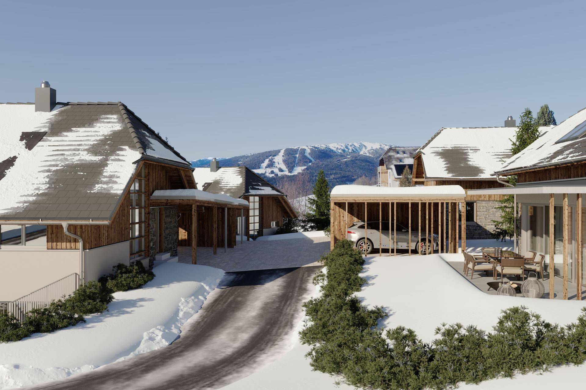 Mehrere moderne Häuser in verschneiter Umgebung mit Carport, Zufahrt und möblierter Terrasse.