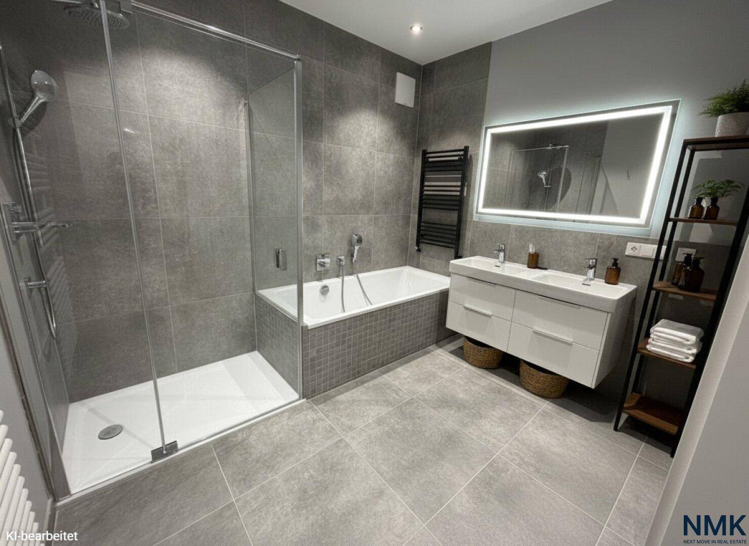 Stilvolles Badezimmer mit grauen Fliesen, Dusche, Badewanne und beleuchtetem Spiegel.