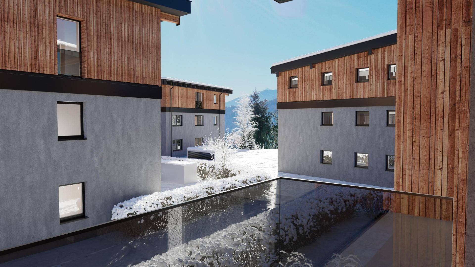 Winterliche Ansicht moderner Wohngebäude mit Holzelementen und Glasbalkonen.