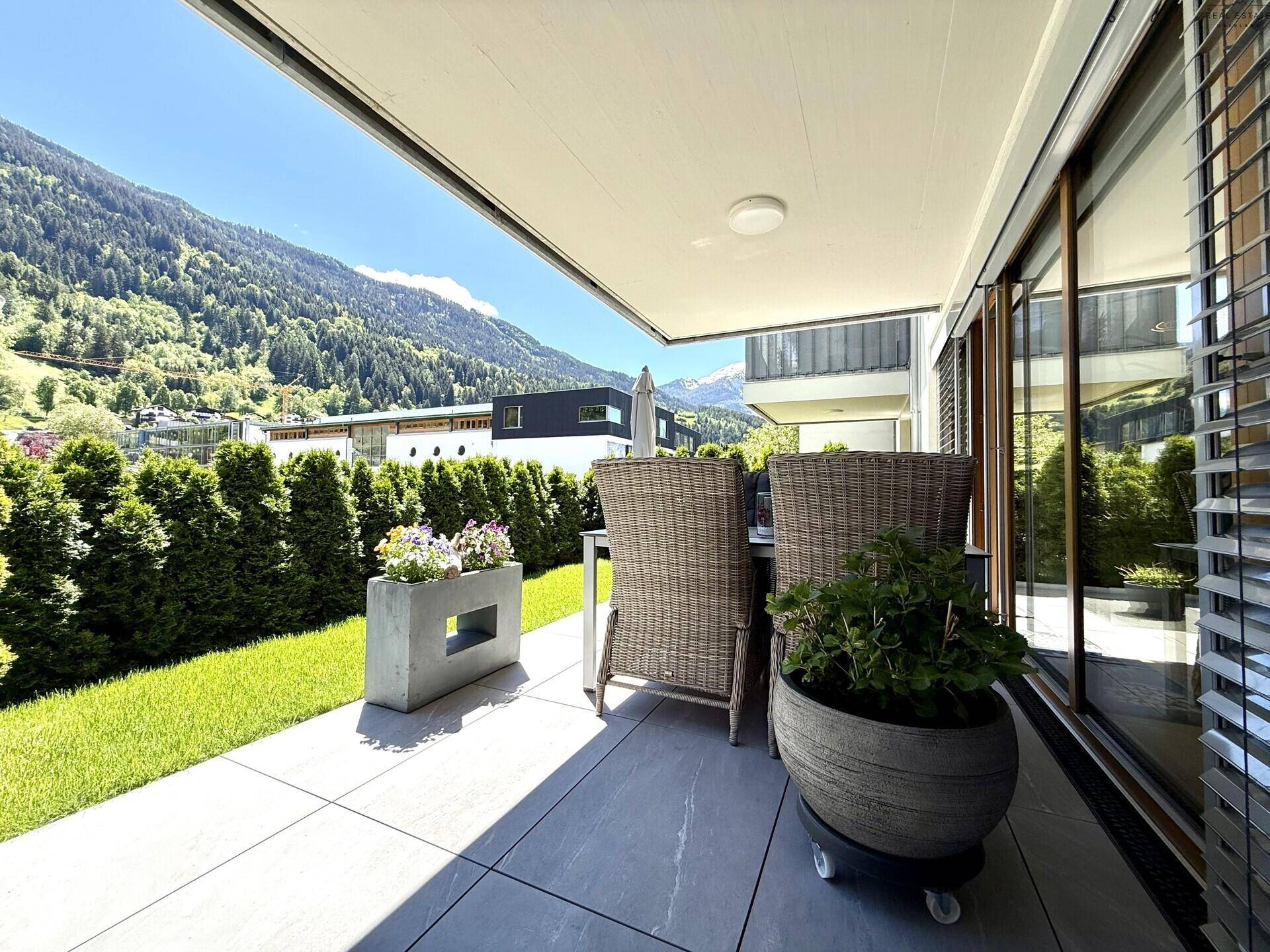Geräumige Terrasse mit Sitzgelegenheiten, Markise und herrlichem Bergblick.