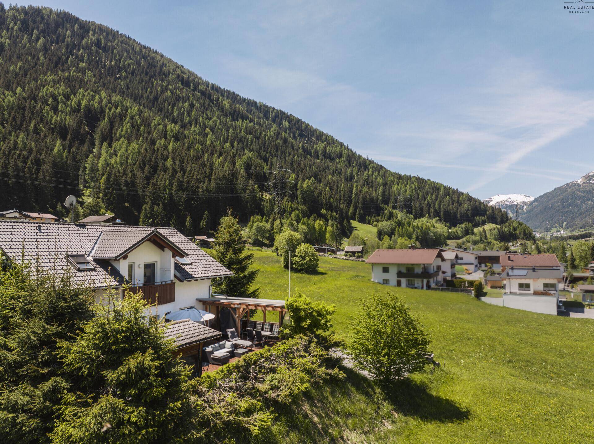 Malerisches Haus in alpiner Landschaft mit grünen Wiesen und Bergblick.