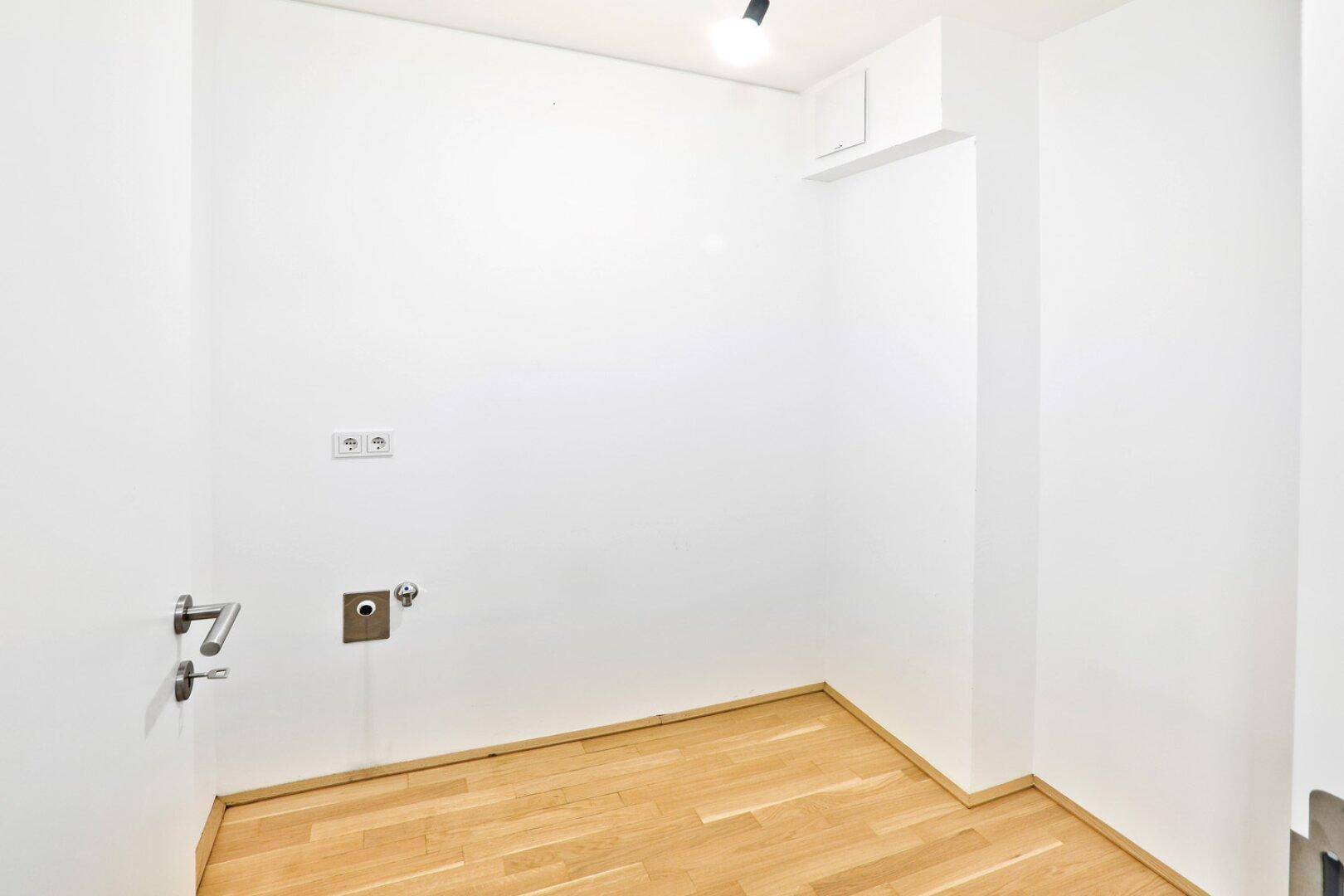 Praktischer Hauswirtschaftsraum mit Anschlüssen für Waschmaschine und Trockner, ideal für den Alltag.