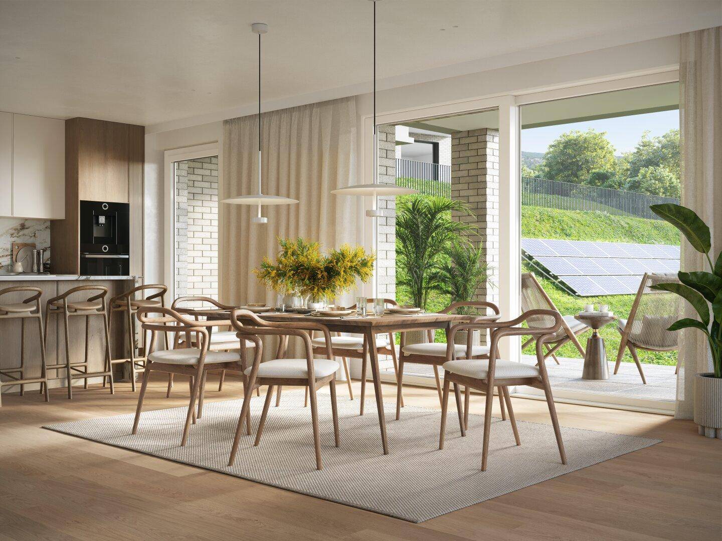 Heller Essbereich mit Holztisch und Zugang zur Terrasse, angrenzend an eine moderne Küche mit Frühstücksbar.