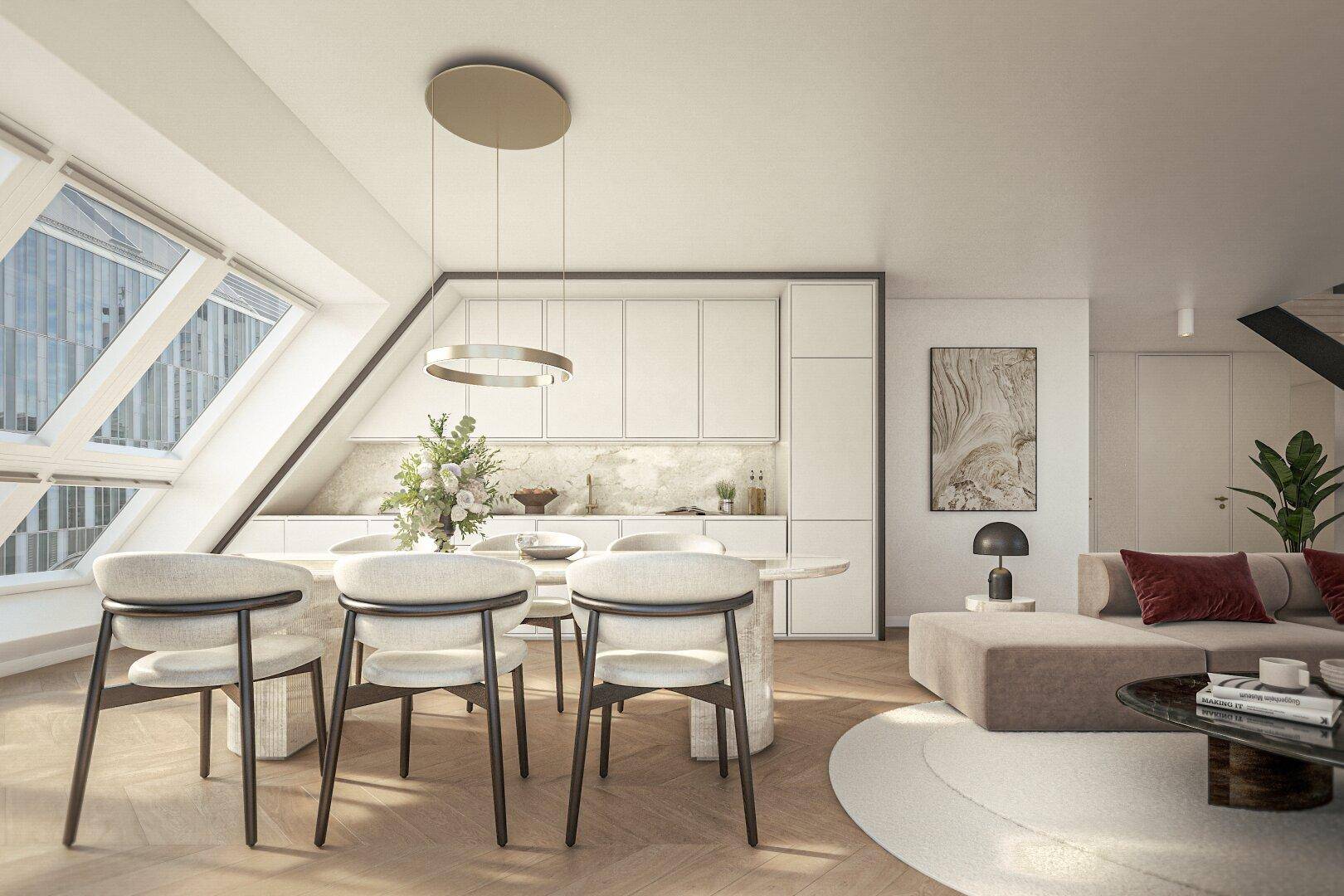 Helles Dachgeschoss-Wohnzimmer mit offener Küche und Essbereich unter schrägen Dachfenstern.