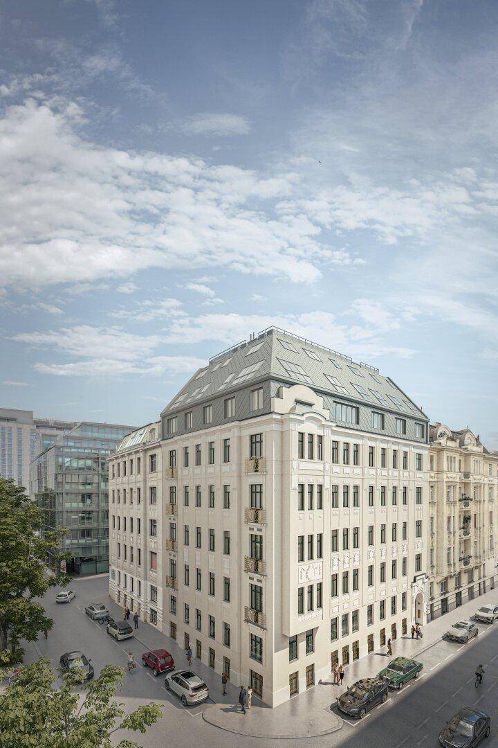 Repräsentatives Eckgebäude mit Mansarddach und klassischer Architektur an einer belebten Stadtstraße.