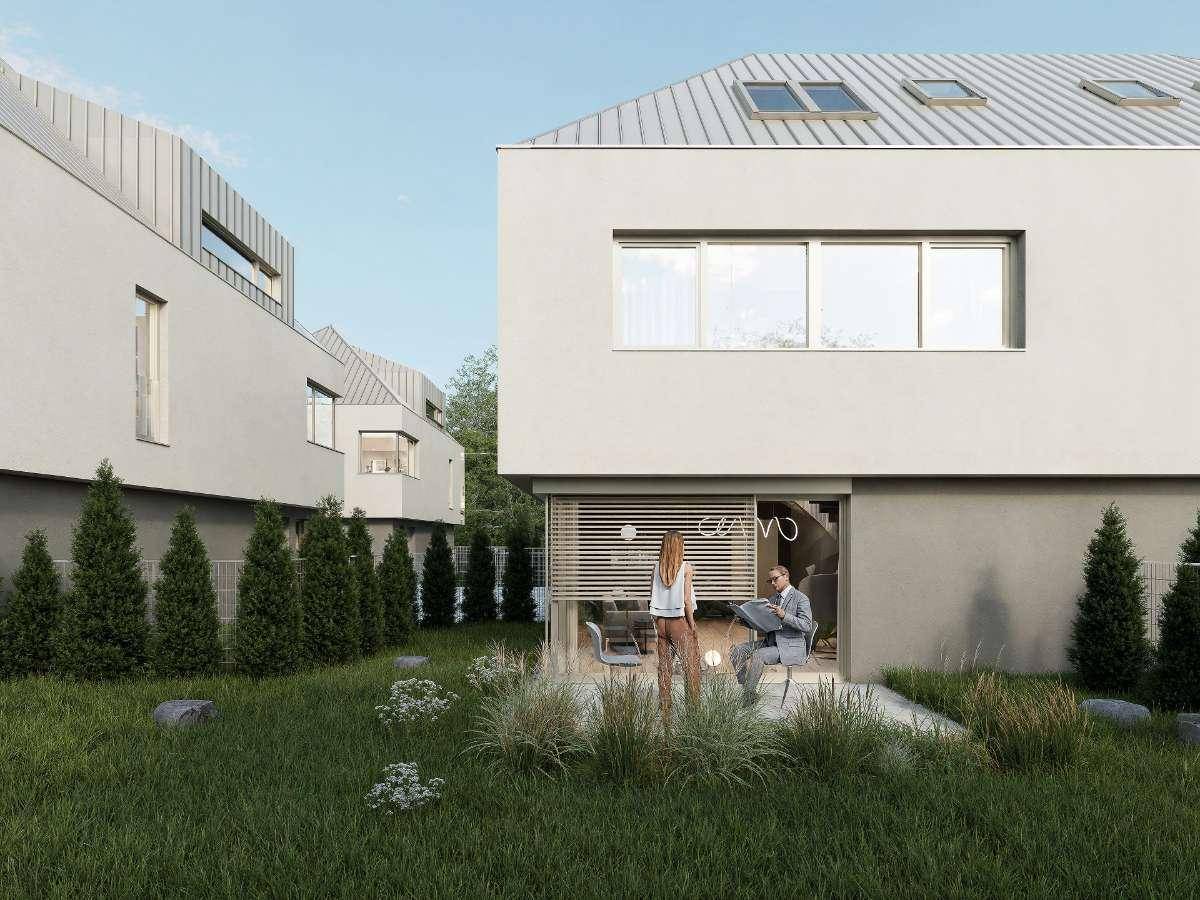Gartenbereich mit Sitzgelegenheit und Blick auf die moderne Architektur der Reihenhäuser.