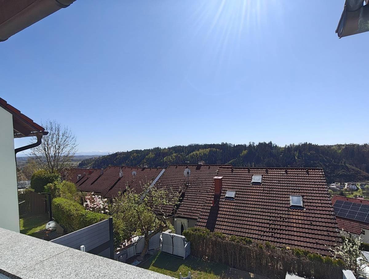 Panoramablick über die Dächer der Nachbarschaft und die umliegende grüne Landschaft.