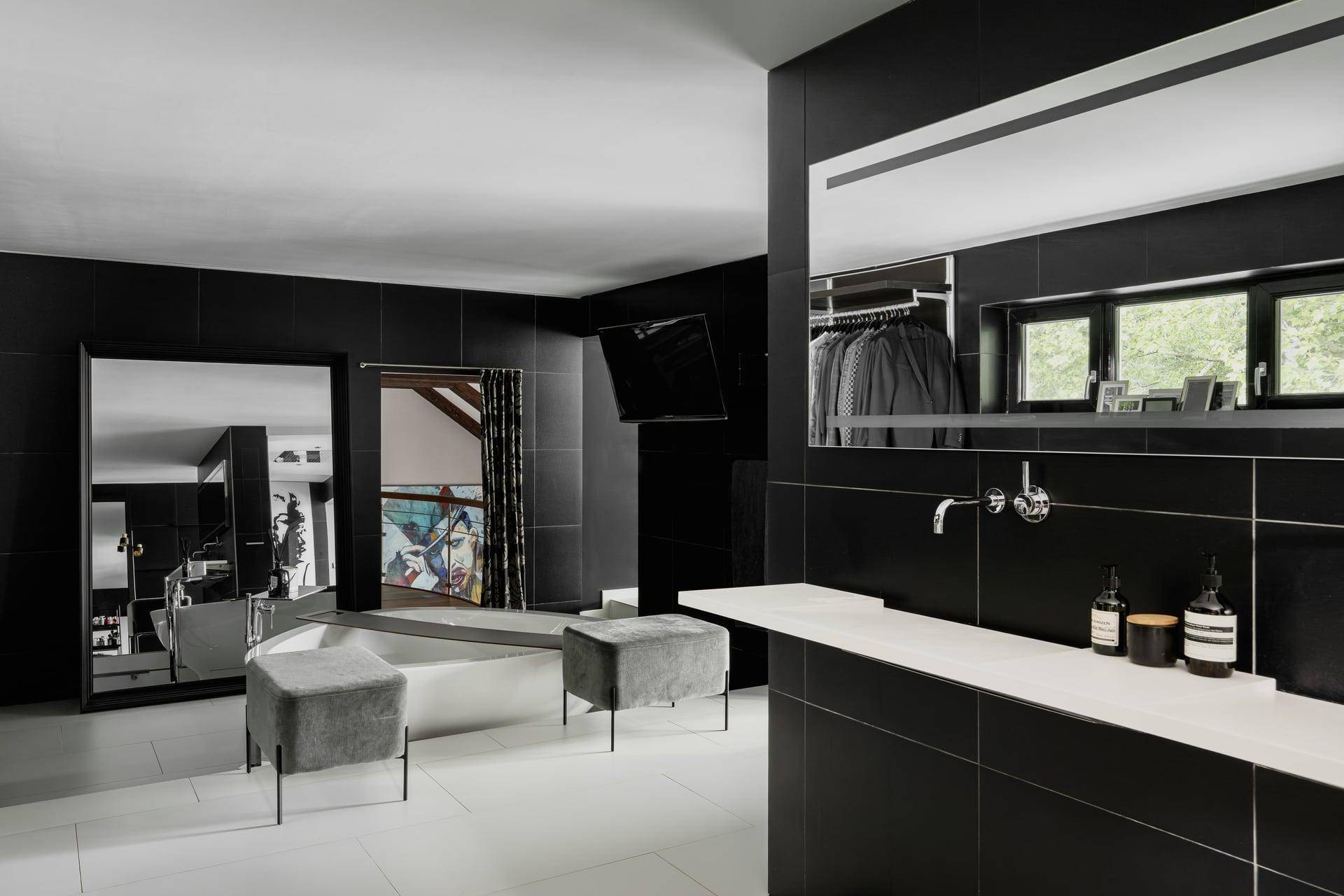 Elegantes Badezimmer in Schwarz-Weiß mit Doppelwaschbecken, Badewanne und Fensterblick.