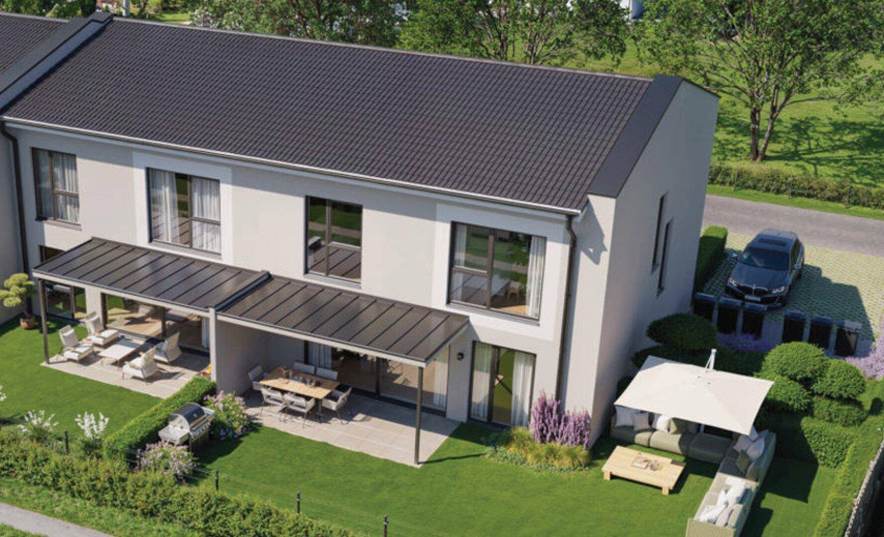 Vogelperspektive der Reihenhäuser mit großzügigen Gärten, Terrassen und Parkplätzen.