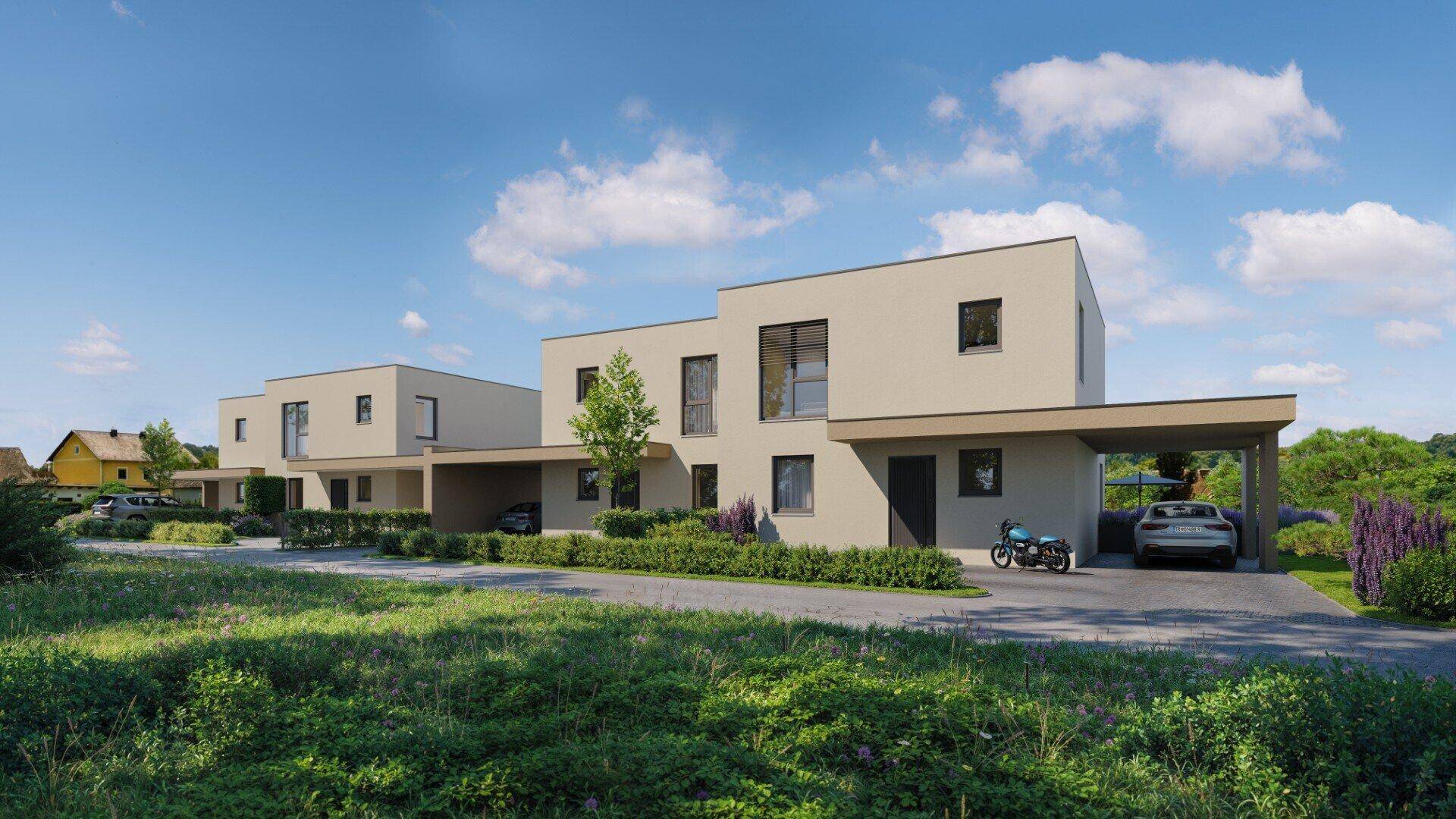 Moderne Doppelhaushälften mit Carports und gepflegter Vorgartenlandschaft unter blauem Himmel.