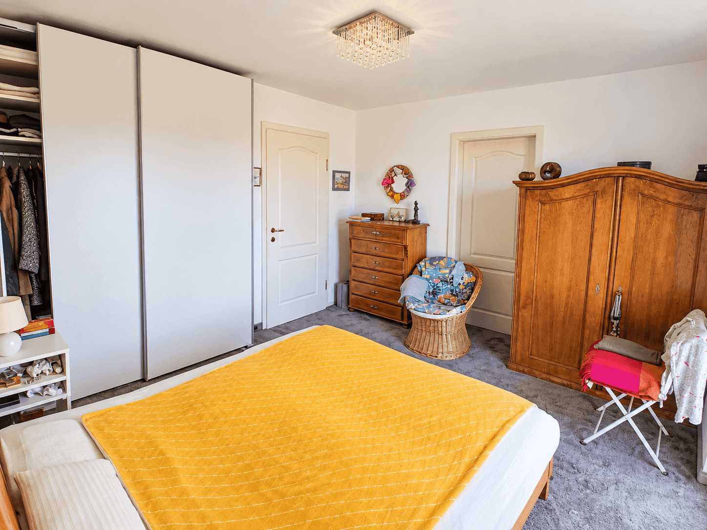 Schlafzimmer mit großem Bett, Einbauschränken und Teppichboden.