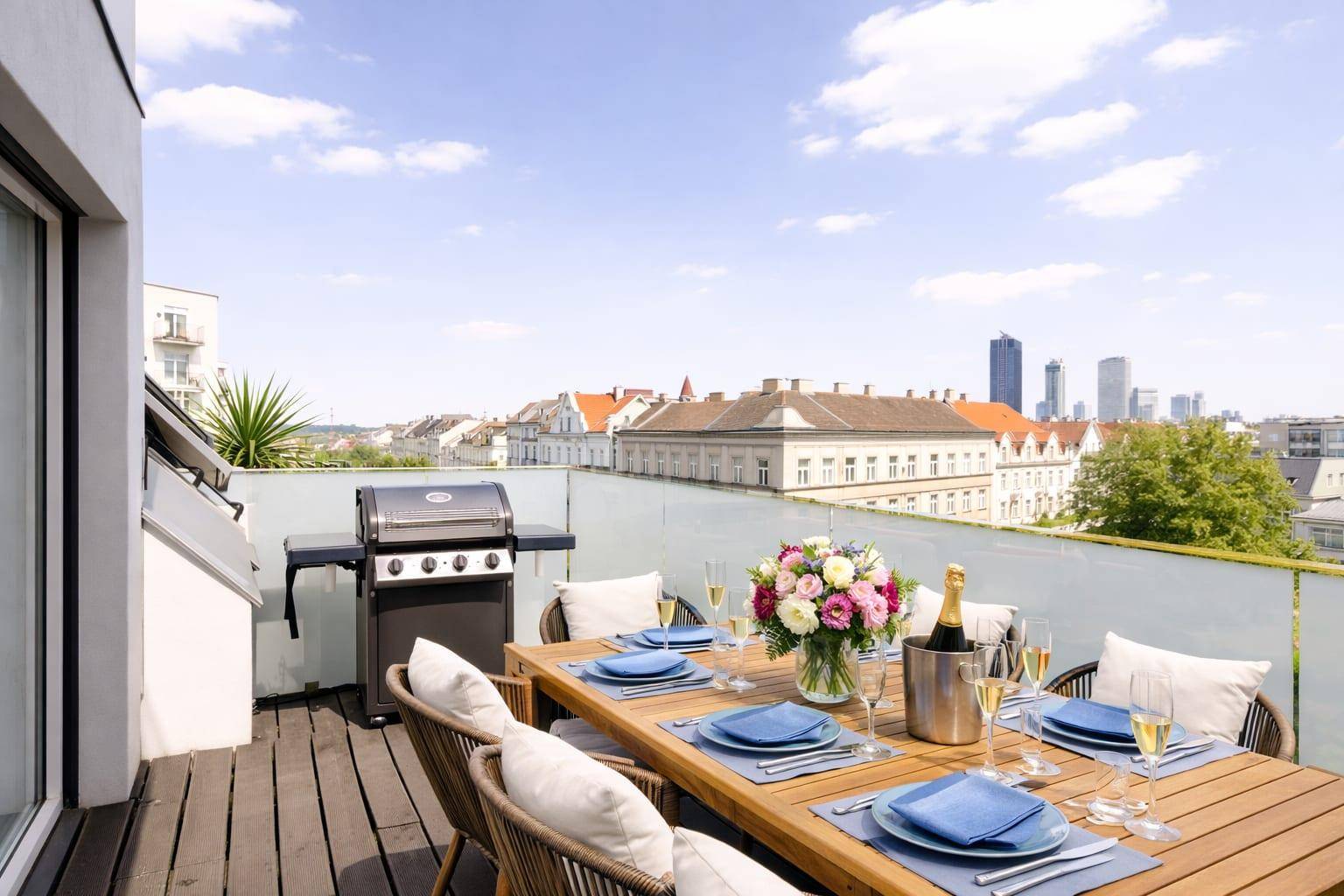 Dachterrasse mit Esstisch, Grill und Panoramablick auf die Stadt.