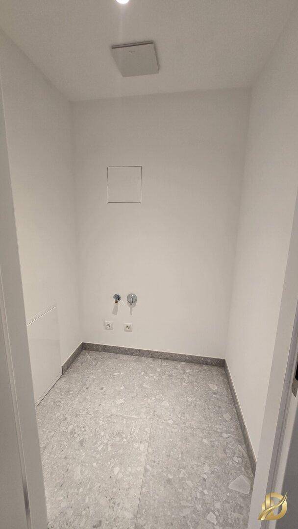 Praktischer Hauswirtschaftsraum mit Anschlüssen für Waschmaschine und Trockner.