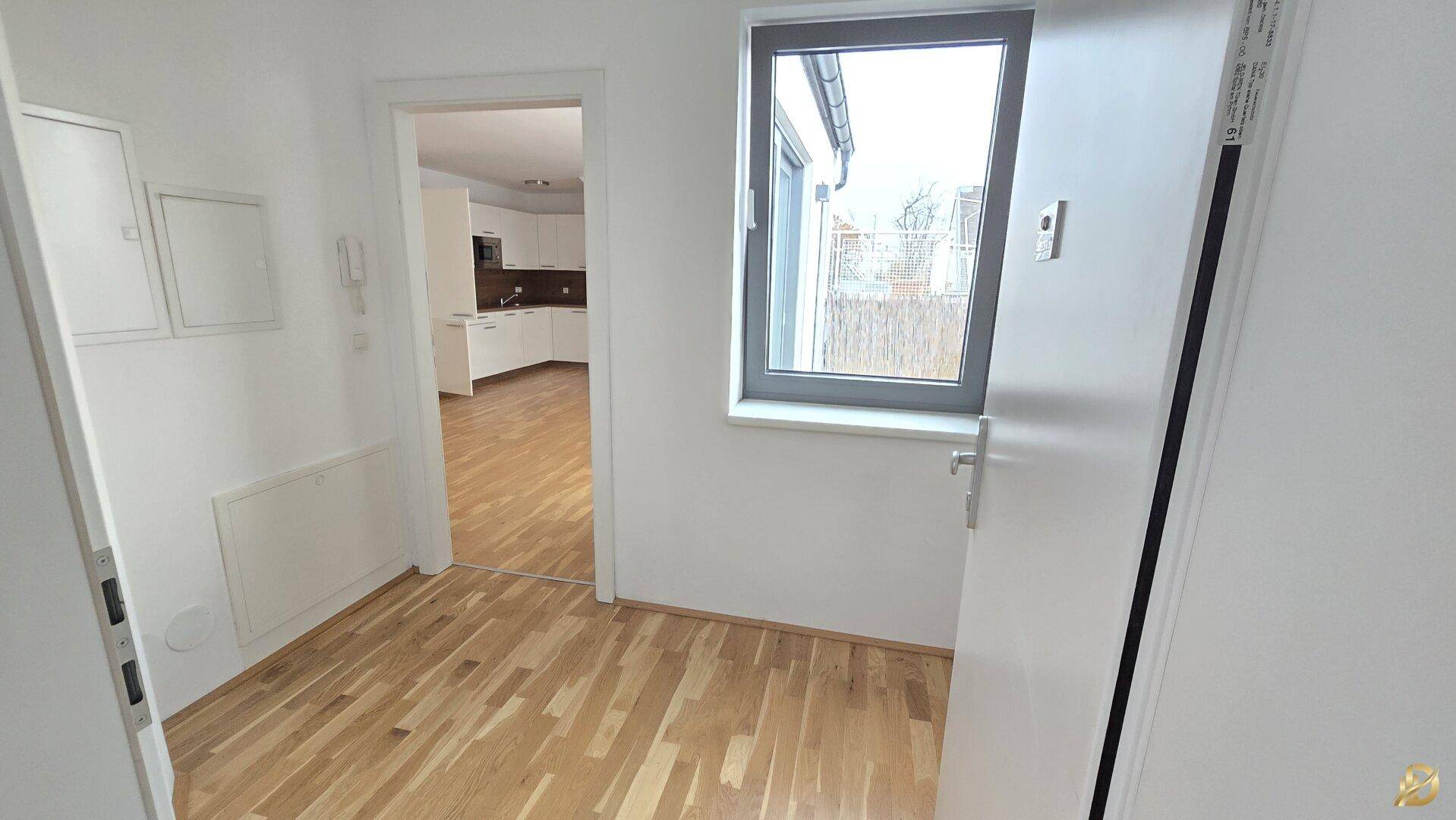 Heller Flur mit Holzboden und Zugang zu verschiedenen Räumen der Wohnung, sehr einladend.