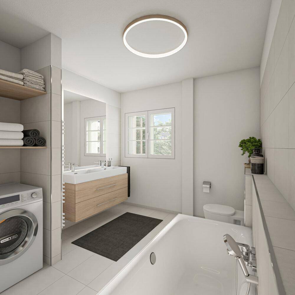 Modernes Badezimmer mit Badewanne, Waschmaschine, Holzwaschtisch und Fenster für Tageslicht.